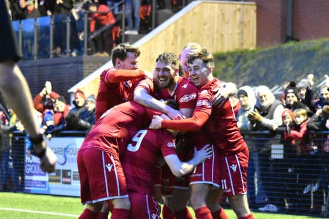James Walshaw is mobbed after scoring against Warrington.
Picture by Morgan Exley