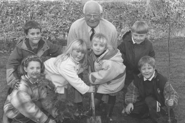 Hugh Helm, from the International Tree Federation, who joined Barrowcliff Infants School pupils, from left, Stacey Howard, Josh Ireland, Jade Jones, Laura Errington, Ashley Grime, and Philip Meades, in a tree planting session in 1996.