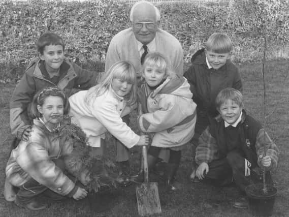 Hugh Helm, from the International Tree Federation, who joined Barrowcliff Infants School pupils, from left, Stacey Howard, Josh Ireland, Jade Jones, Laura Errington, Ashley Grime, and Philip Meades, in a tree planting session in 1996.