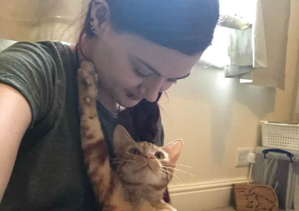 One-year-old ginger tom cat Charlie with his fosterer Claire Louise Welsh.
