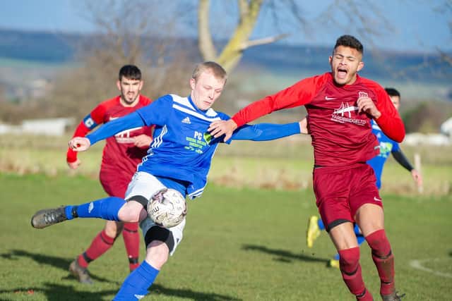 Trafalgar's Danny Glendinning is put under pressure by Lloyd Henderson. Picture by Andy Standing.