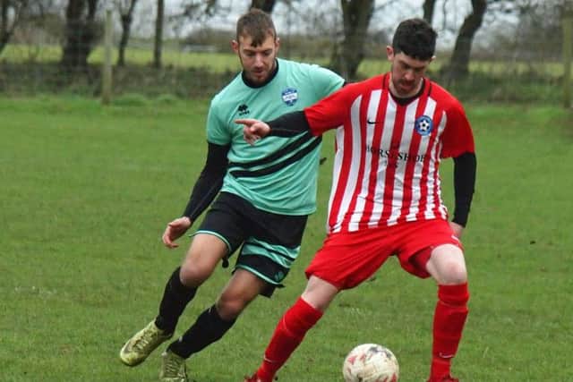 Hunmanby's Dan Baldry is put under pressure by Mikey Barker