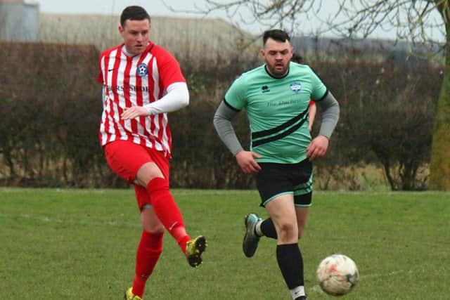 Hunmanby player-boss Leigh Franks picks out a teammate