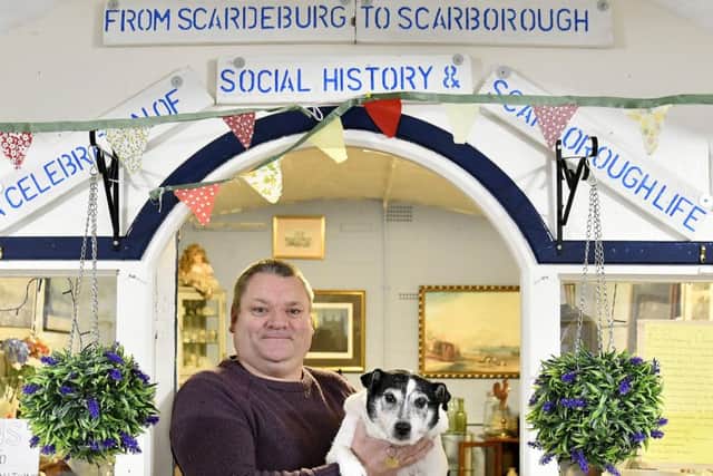 From Scarborough to Scarborough. Wayne Murray and his dog outside his shop