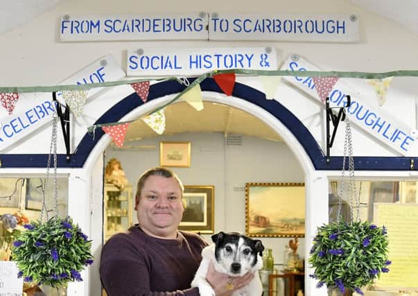 From Scarborough to Scarborough. Wayne Murray and his dog outside his shop