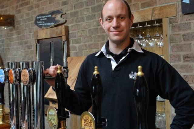 Wold Top Brewery Manager, Alex Balchin, behind the bar.