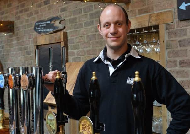 Wold Top Brewery Manager, Alex Balchin, behind the bar.