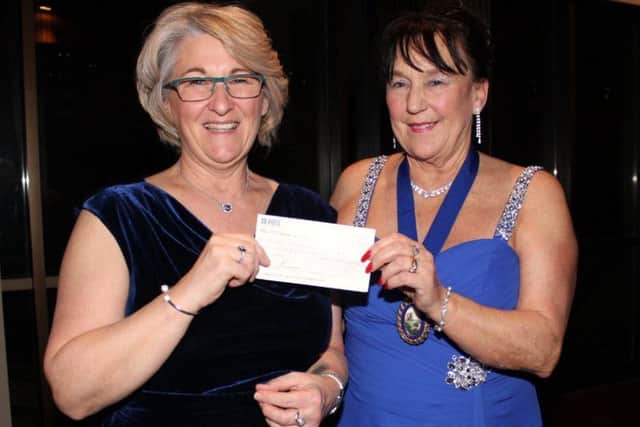 Elizabeth McPherson is presented with a cheque by Shirley Smith.