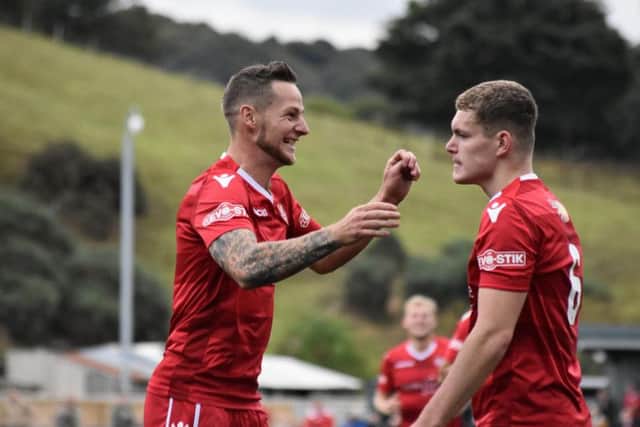Bailey Gooda celebrates a goal with Wayne Brooksby