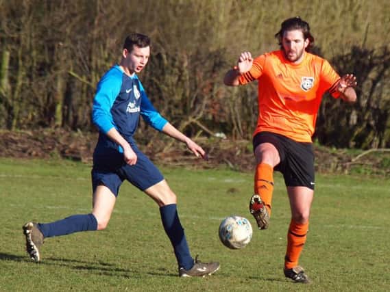 Snainton, orange kit, battle it out in their 5-0 home win against FC Rosette