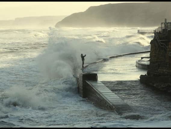 The shot of the man standing on the sea wall was taken by reader Michael Knaggs.