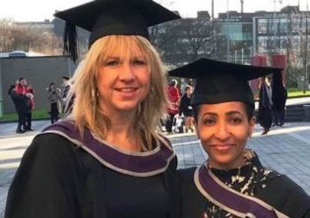 Claire Davey and Faizah Tahir are pictured at their graduation.