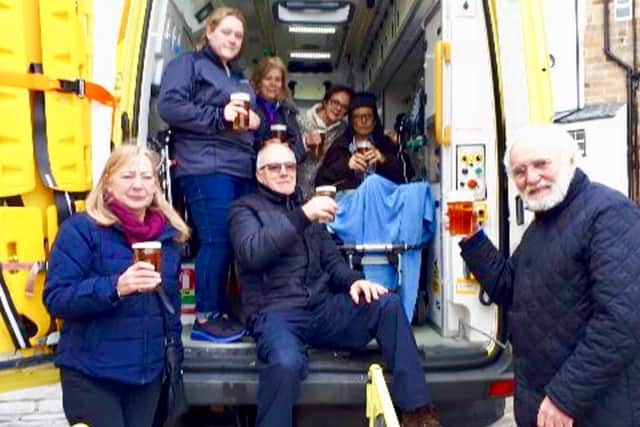 Steve, back right, enjoys a pint of his favourite beer at Robin Hood's Bay surrounded by family and friends.