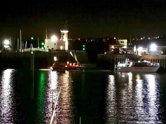 The boat being towed into Scarborough Harbour.