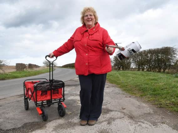 Lisa Crosier is able to continue with her litter picking around Bempton, thanks to local builder Craig Ramsden, who has bought her a new trolley.