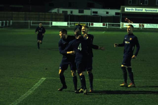 Gary Hepples is mobbed after levelling up for Edgehill Reserves
