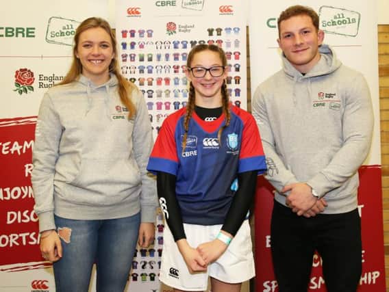 Bridlington Schools Cerys Reece receives the new school kit from England internationals Zoe Aldcroft and Sam Underhill