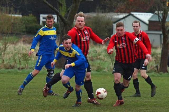 Seamer (blue kit) and West Pier battle for the ball. Picture by Steve Lilly.