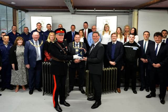 David Kerfoot MBE presents representatives of Cast Iron Radiators Ltd with the Queens Award for Enterprise.