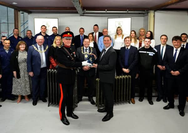 David Kerfoot MBE presents representatives of Cast Iron Radiators Ltd with the Queens Award for Enterprise.