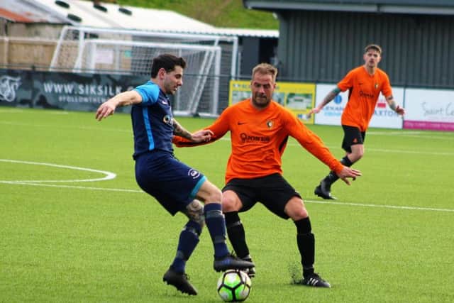Edgehill man of the match Jamie Patterson closes down Pier's Sam Garnett
