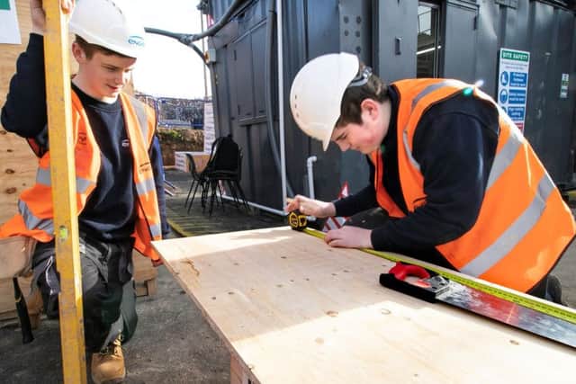 Apprentices Brandon Toulson (left) and Dan Miller are pictured at work.