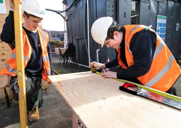 Apprentices Brandon Toulson (left) and Dan Miller are pictured at work.