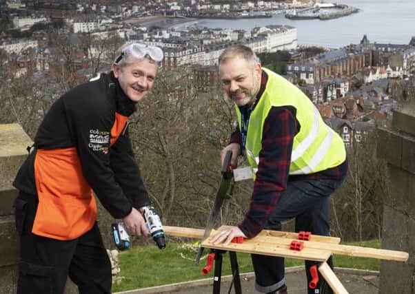 Charlie Macleod, manager of the B&Q store in Scarborough, and Ed Horwood, from the Youth Justice Service, try out the new equipment in Scarborough.