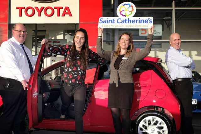 Car winner Phoebe Dixon celebrates with dad Andy, Vantage Toyota centre principle Peter Stableford and Saint Catherines Hospice communications and marketing manager Susan Stephenson. Photo by Richard Ponter