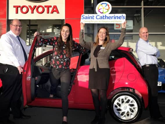 Car winner Phoebe Dixon celebrates with dad Andy, Vantage Toyota centre principle Peter Stableford and Saint Catherines Hospice communications and marketing manager Susan Stephenson. Photo by Richard Ponter