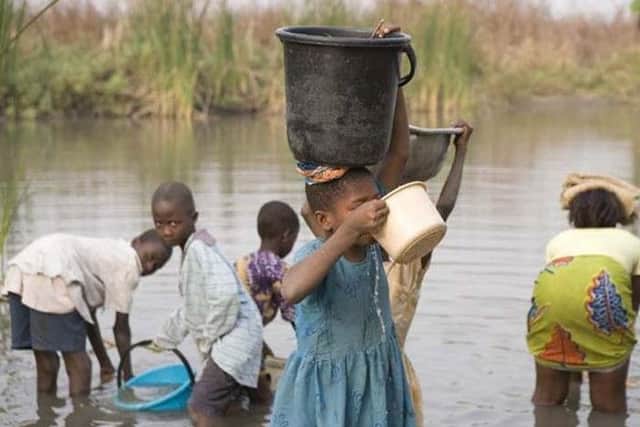 Villagers travelling to collect dirty water.