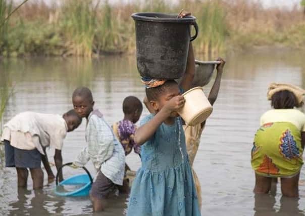 Villagers travelling to collect dirty water.