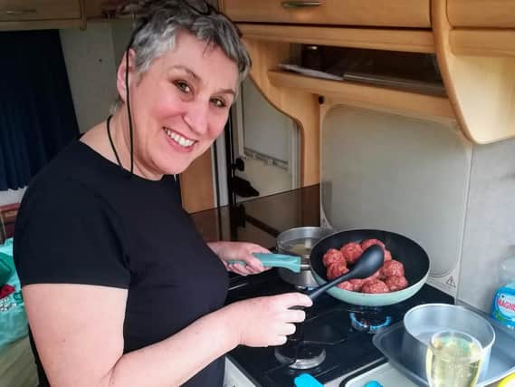 Karen whips up some meatballs in the caravan kitchen.
