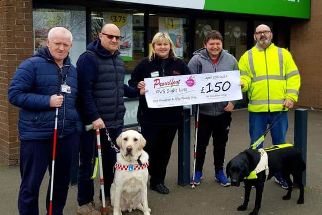RVS Sight Loss members collect the £150 cheque from the Proudfoot Group.