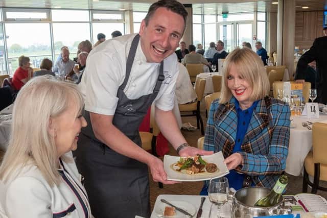 James Mackenzie serves his special main course to sisters Vivien Fulton, left, and Hazel Morfitt in The Attraction restaurant at Beverley Racecourse.