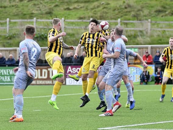 Jack Johnson wins a header during Saturday's mauling of Workington