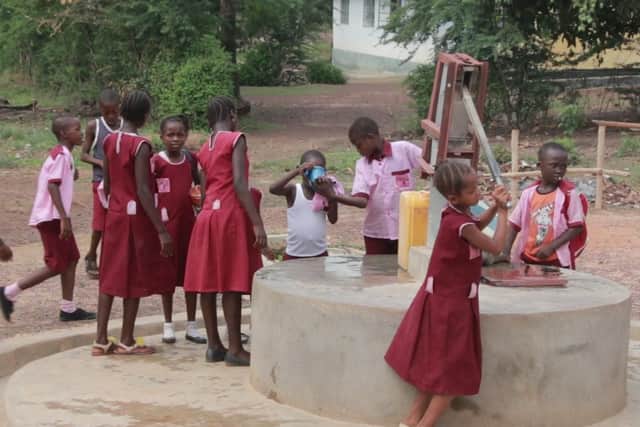 Pupils at the school's water well.