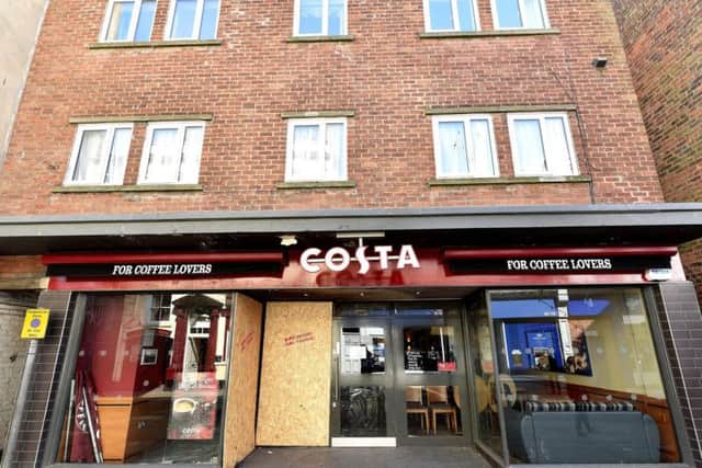 Part of the shop front is boarded up following the fire damage