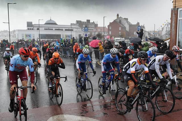 Rain lashes the riders on the start line, as stage three gets underway.