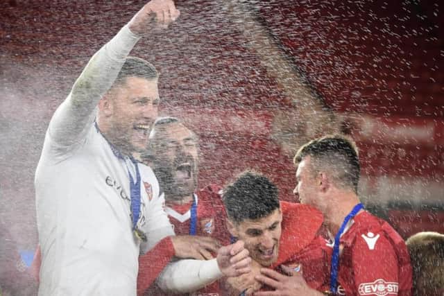 Tommy Taylor, left, celebrating the cup win