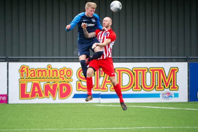 Pier striker Rich Tolliday beats Mike Johnson to this header