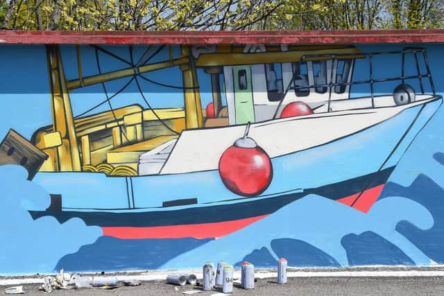 The mural features seaside-themed images.