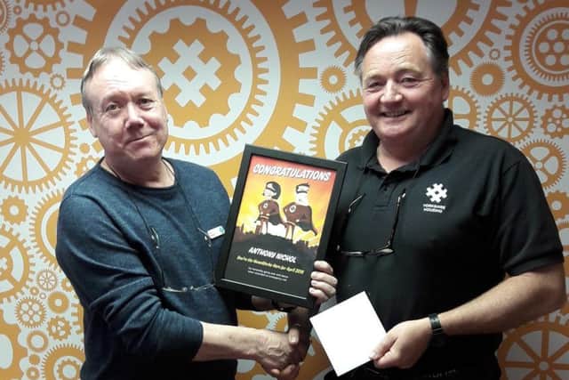 Anthony Nichol, right, receives his hero award from Paul Roberts.
