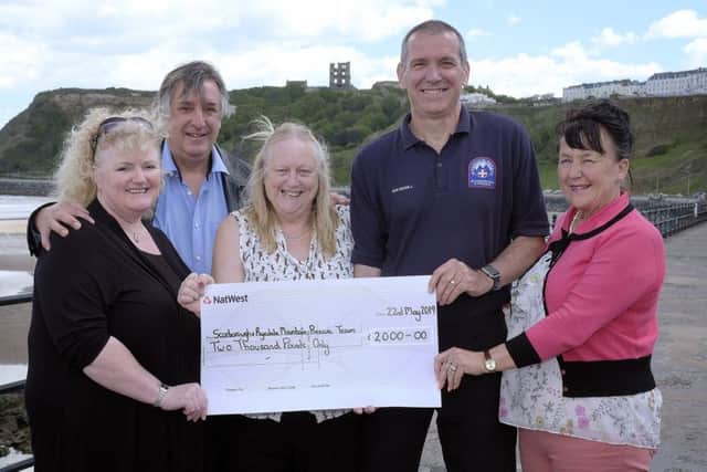 Members of Scarborough Hospitality Association present the cheque to the mountain rescue team.