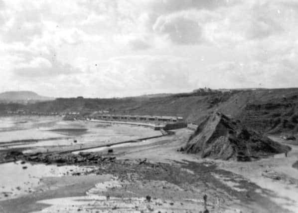 Picture shows a view of the North Bay with an undeveloped Scalby Mills in the foreground. The island on the right was known as Monkey Island and was a popular playground for many generations. The island was flattened when the sea wall and promenade were extended to northwards to Scalby Beck