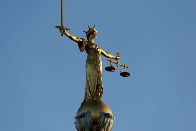 FW Pomeroy's Statue of Justice stands atop the Central Criminal Court building, Old Bailey, London.