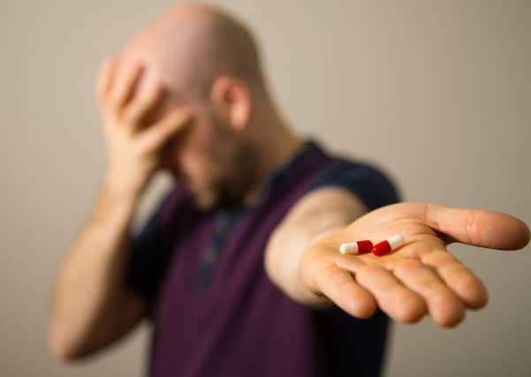 A man holding painkillers.