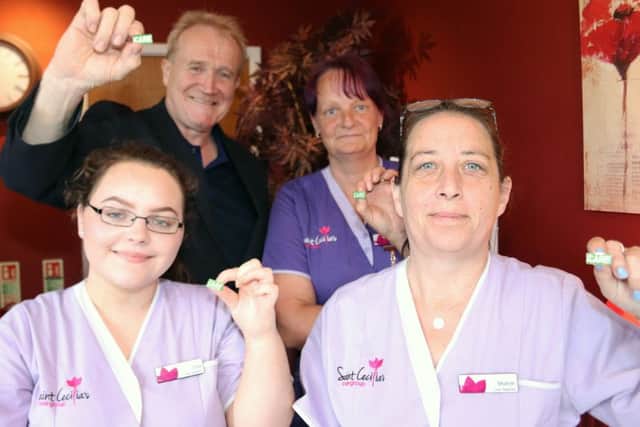 Staff at Scarborough care provider Saint Cecilias with their CARE badges.