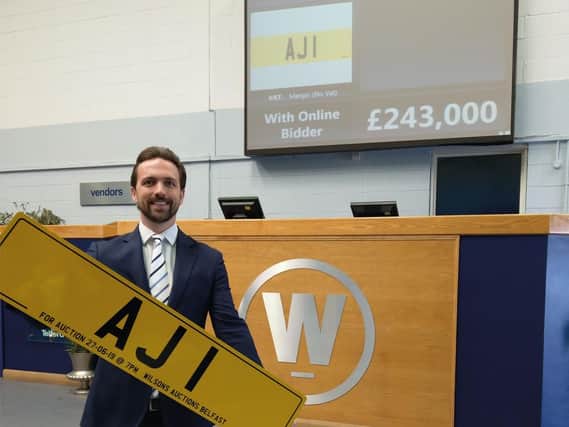 Auctioneer John Ardill with the AJ1 number plate.