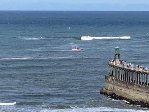 Four people have been rescued after a vessel capsized.